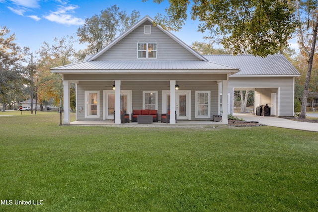 back of property featuring covered porch, a yard, and an outdoor hangout area