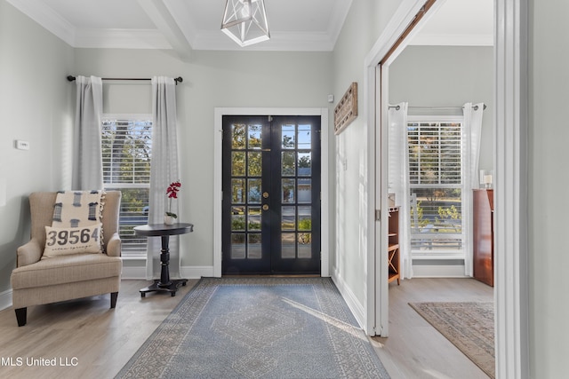 entrance foyer featuring french doors, ornamental molding, and hardwood / wood-style floors