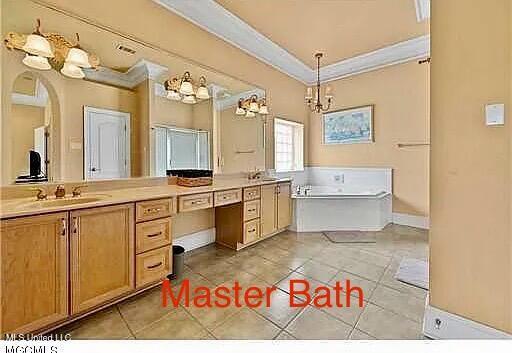 full bath with tile patterned flooring, double vanity, crown molding, and a sink