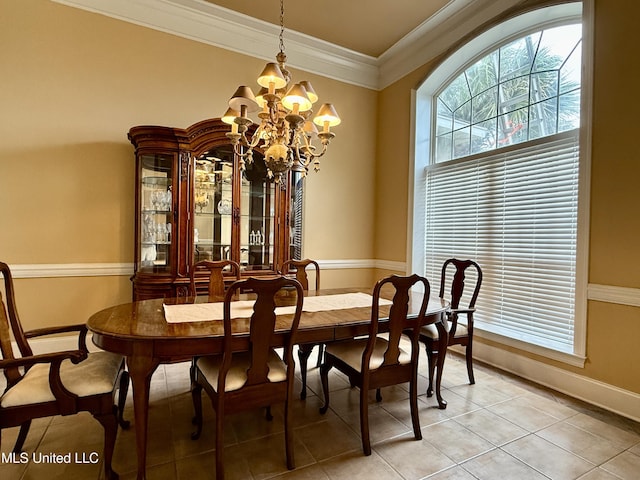 dining room with a chandelier, light tile patterned flooring, baseboards, and ornamental molding