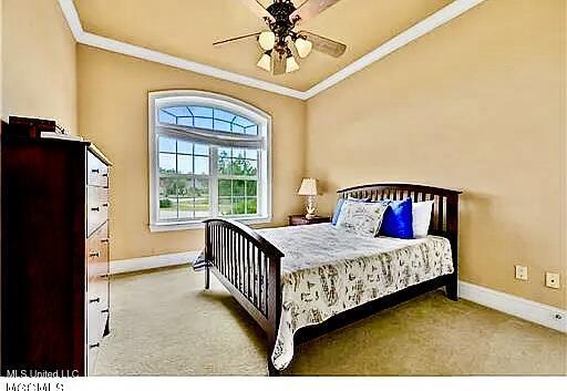 bedroom featuring carpet flooring, baseboards, and ornamental molding