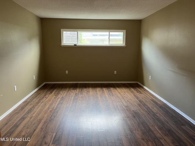 2 Concord Pl, Gulfport, MS 39507 - empty room featuring dark wood-style flooring and baseboards