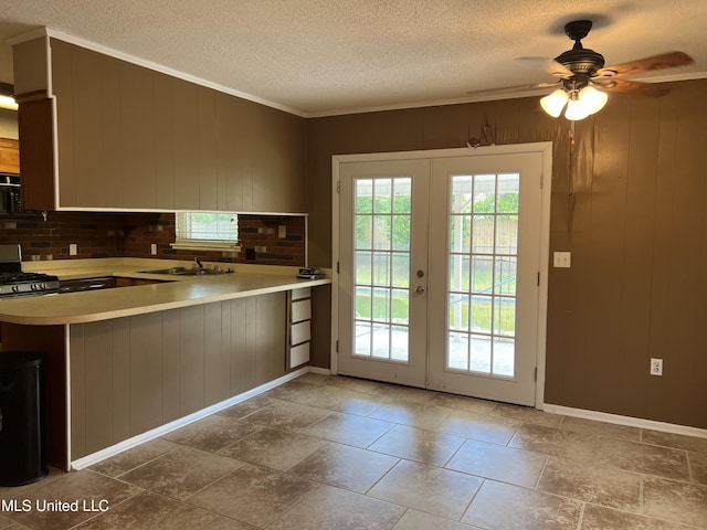 2 Concord Pl, Gulfport, MS 39507 - kitchen featuring french doors, a textured ceiling, a ceiling fan, light countertops, and crown molding