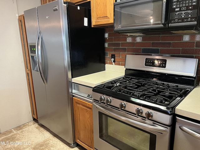 2 Concord Pl, Gulfport, MS 39507 - kitchen featuring stainless steel appliances, light countertops, tasteful backsplash, and brown cabinets