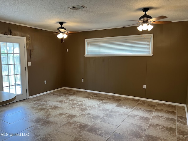 2 Concord Pl, Gulfport, MS 39507 - unfurnished room with ceiling fan, a textured ceiling, wood walls, and crown molding