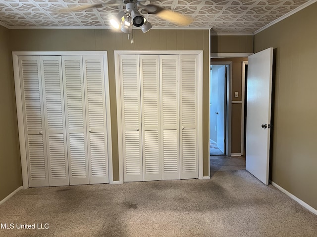 2 Concord Pl, Gulfport, MS 39507 - unfurnished bedroom featuring an ornate ceiling, multiple closets, carpet flooring, crown molding, and ceiling fan
