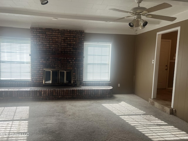 2 Concord Pl, Gulfport, MS 39507 - unfurnished living room featuring carpet floors, ceiling fan, and a brick fireplace
