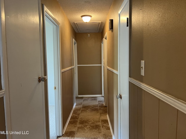 2 Concord Pl, Gulfport, MS 39507 - corridor with attic access, dark stone finish flooring, and a textured ceiling