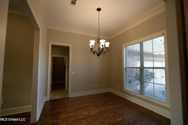 unfurnished dining area with dark hardwood / wood-style flooring, ornamental molding, and a chandelier