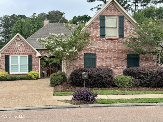 771 Versailles Dr, Ridgeland, MS 39157 - traditional-style house featuring a chimney, brick siding, and roof with shingles