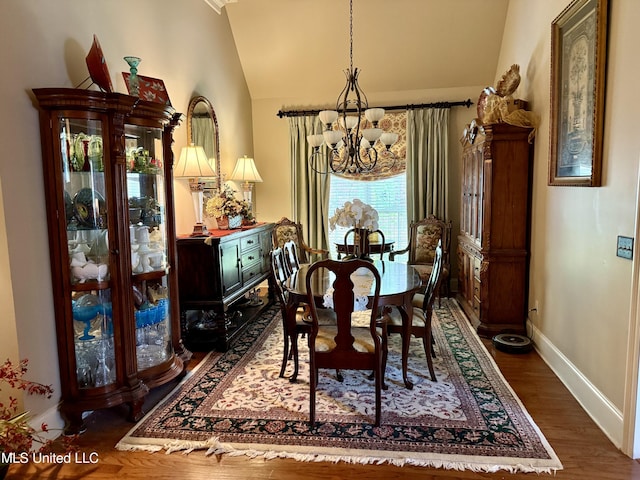 771 Versailles Dr, Ridgeland, MS 39157 - dining area featuring a chandelier, vaulted ceiling, baseboards, and dark wood-type flooring