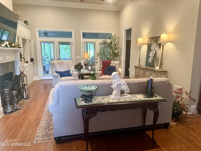 771 Versailles Dr, Ridgeland, MS 39157 - living room featuring a ceiling fan, wood finished floors, ornamental molding, a tile fireplace, and baseboards