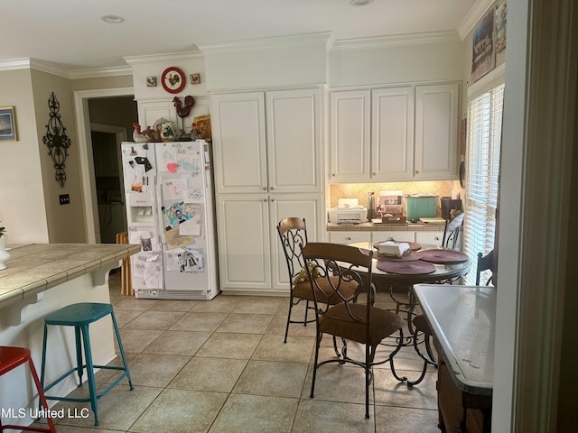 771 Versailles Dr, Ridgeland, MS 39157 - dining room with ornamental molding and light tile patterned floors