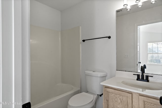 full bathroom with toilet, vanity, and tub / shower combination