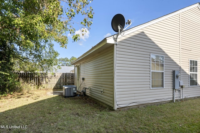 view of property exterior featuring a yard and central AC unit