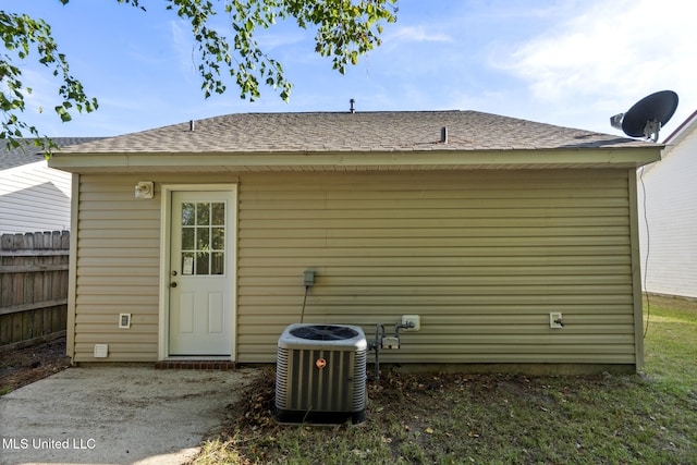 back of house featuring central air condition unit