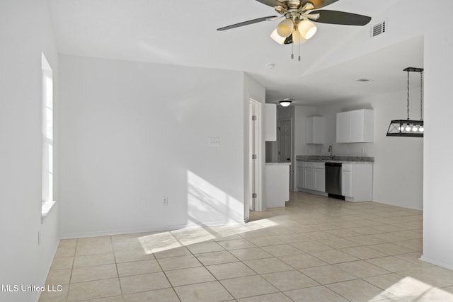 spare room featuring sink, ceiling fan, vaulted ceiling, and light tile patterned floors