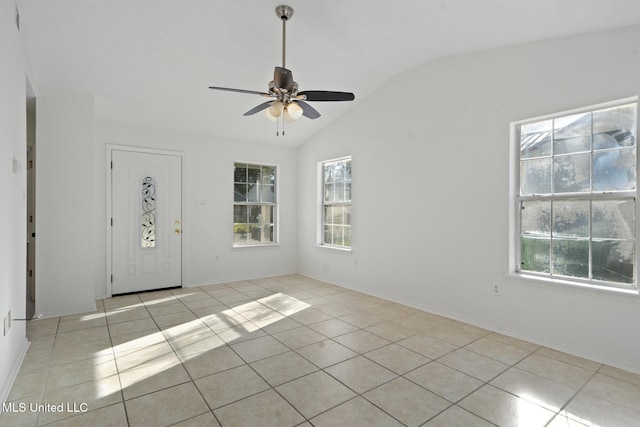 spare room featuring lofted ceiling, ceiling fan, and light tile patterned floors