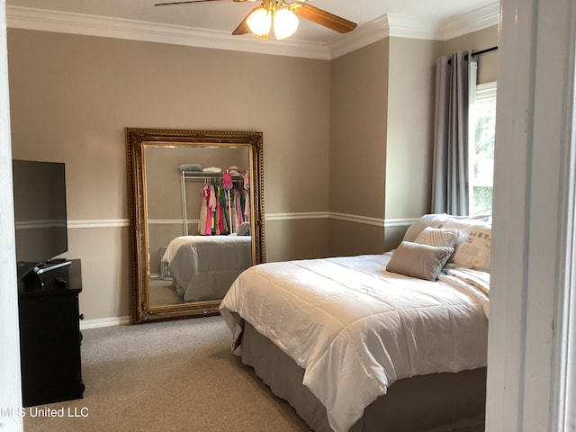8102 Fairway Villa Dr, Gautier, MS 39553 - bedroom featuring a walk in closet, crown molding, carpet floors, a closet, and a ceiling fan