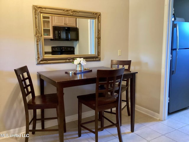 8102 Fairway Villa Dr, Gautier, MS 39553 - dining room featuring baseboards and light tile patterned floors