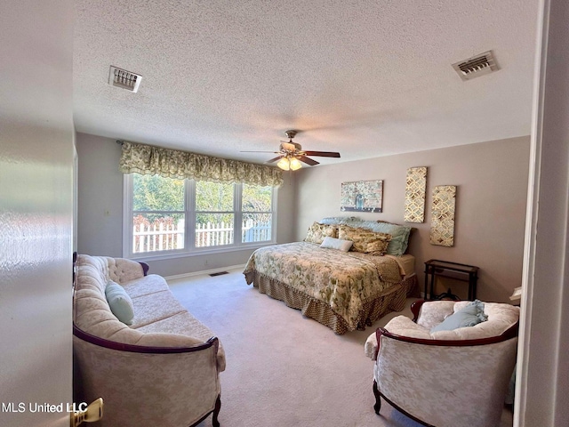 8102 Fairway Villa Dr, Gautier, MS 39553 - bedroom featuring carpet flooring, a textured ceiling, and ceiling fan