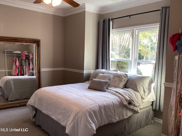 8102 Fairway Villa Dr, Gautier, MS 39553 - carpeted bedroom featuring crown molding, a walk in closet, a closet, and a ceiling fan