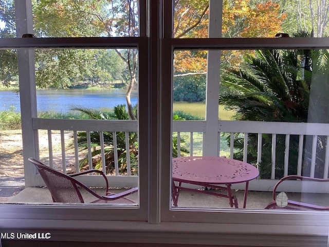 8102 Fairway Villa Dr, Gautier, MS 39553 - doorway featuring a water view and view of scattered trees