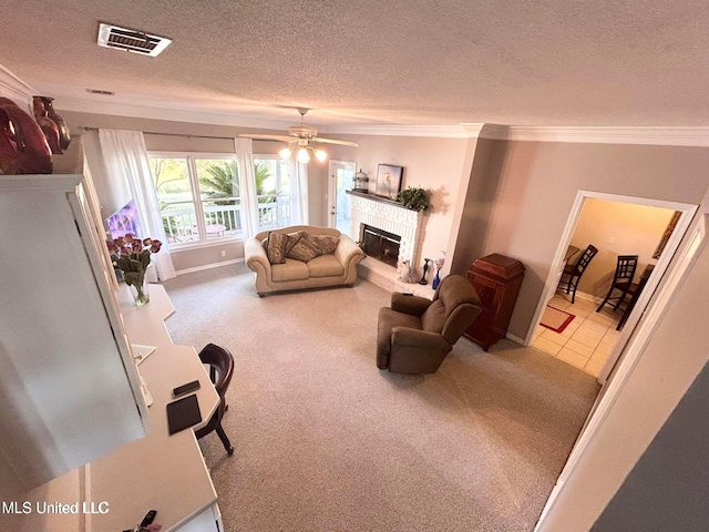 8102 Fairway Villa Dr, Gautier, MS 39553 - carpeted living area with a textured ceiling, a glass covered fireplace, ornamental molding, and a ceiling fan