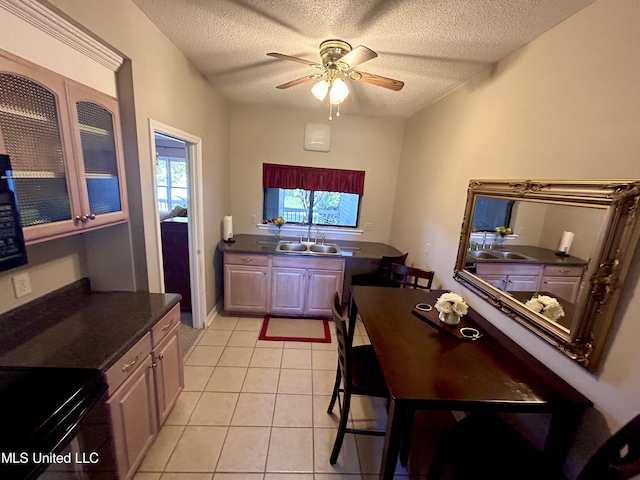 8102 Fairway Villa Dr, Gautier, MS 39553 - kitchen featuring dark countertops, a textured ceiling, a ceiling fan, and light tile patterned floors