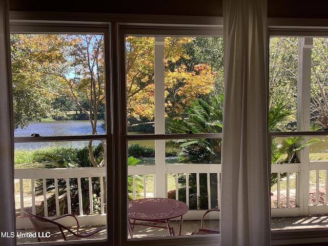 8102 Fairway Villa Dr, Gautier, MS 39553 - doorway to outside with a water view, view of wooded area, and healthy amount of natural light
