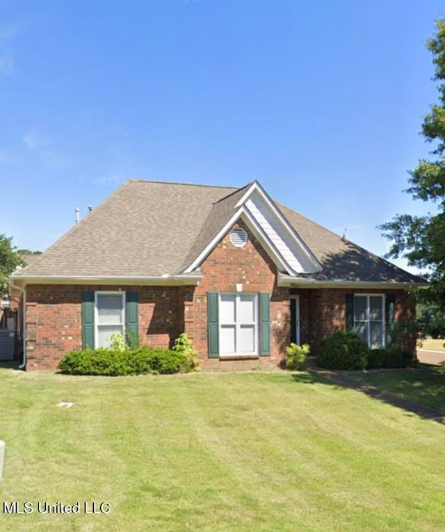 ranch-style home with a front lawn