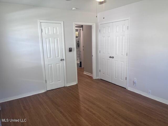 unfurnished bedroom featuring baseboards and wood finished floors