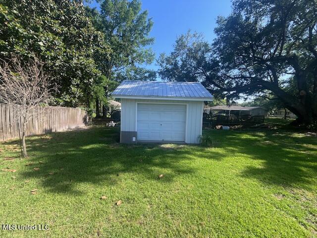 detached garage featuring fence