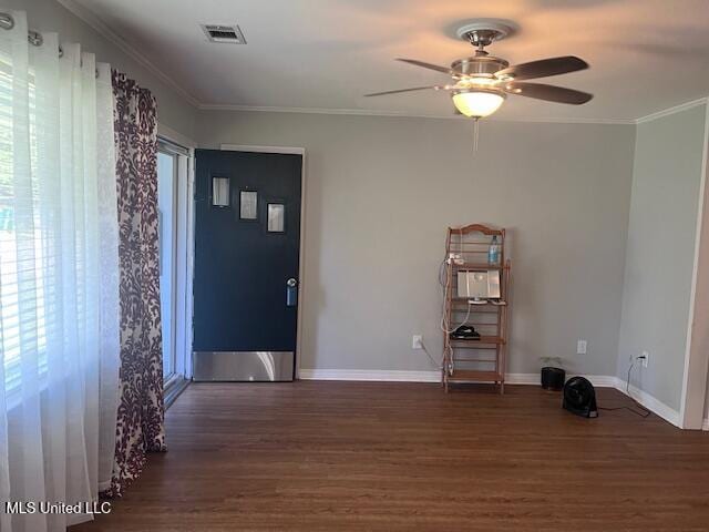 spare room featuring visible vents, baseboards, ceiling fan, and wood finished floors