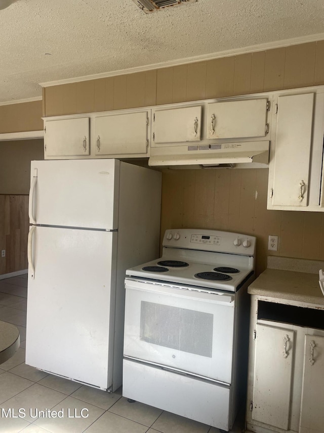 kitchen with white appliances, wooden walls, ornamental molding, under cabinet range hood, and a textured ceiling