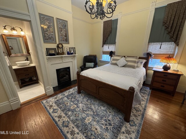 bedroom featuring wood-type flooring, a chandelier, and multiple windows