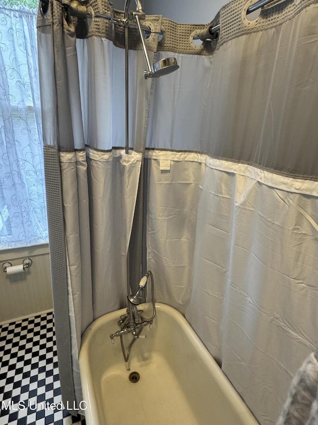full bath with tile patterned floors and shower / tub combo