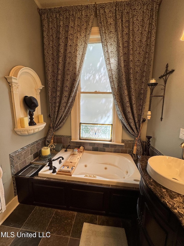 bathroom with a whirlpool tub and a sink