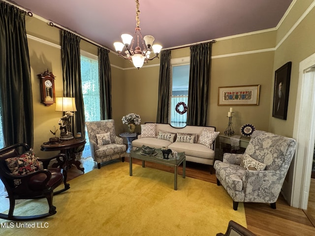 sitting room with crown molding, wood finished floors, and a notable chandelier