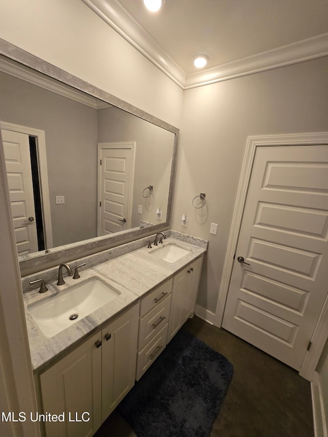 bathroom with ornamental molding and vanity