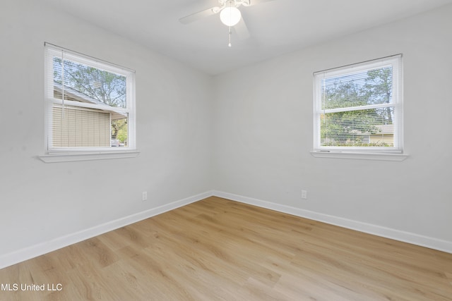 spare room featuring ceiling fan, plenty of natural light, and light wood-type flooring