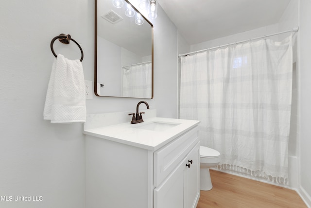 full bathroom with vanity, hardwood / wood-style flooring, toilet, and shower / bathtub combination with curtain