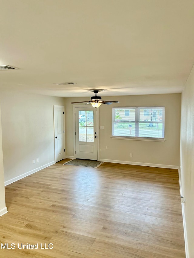 unfurnished room with ceiling fan and light hardwood / wood-style flooring