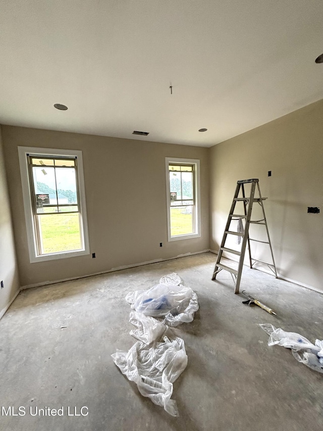 unfurnished room with visible vents
