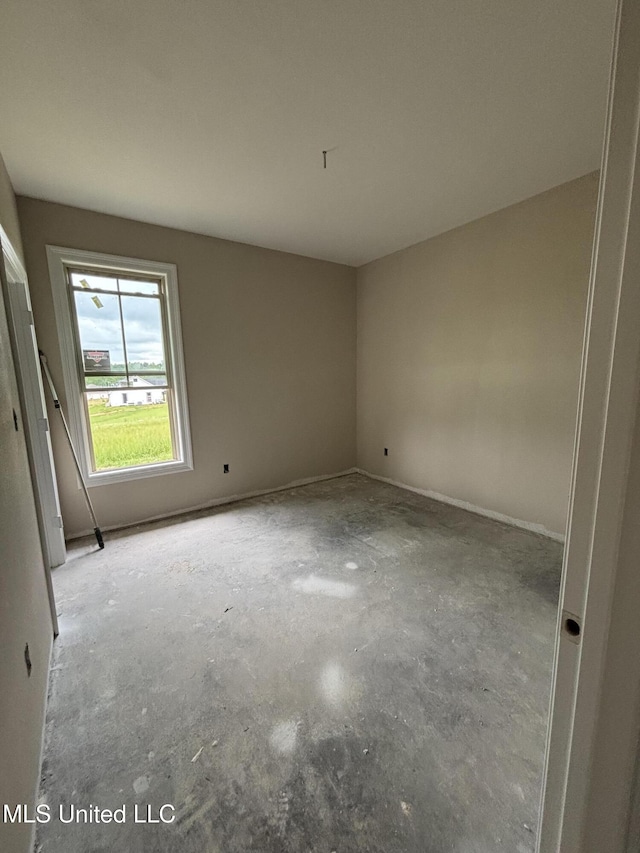 spare room with concrete floors