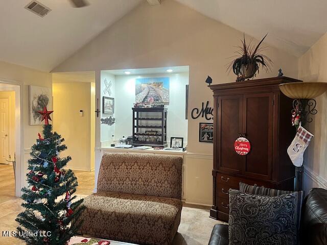 sitting room featuring lofted ceiling with beams