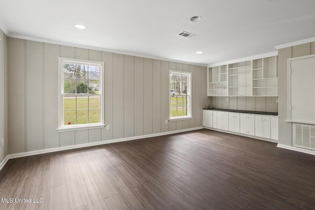 unfurnished living room featuring visible vents, baseboards, ornamental molding, and dark wood-style flooring