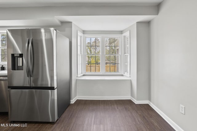 kitchen with dark wood finished floors, baseboards, and stainless steel fridge