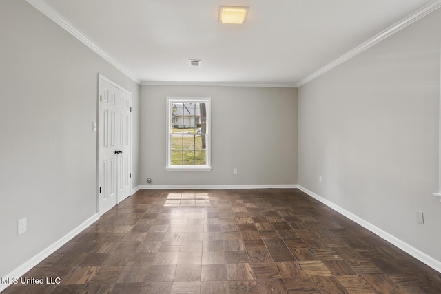 unfurnished room featuring visible vents, baseboards, and ornamental molding