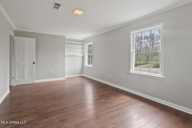 unfurnished room with a wealth of natural light, baseboards, and dark wood-style floors